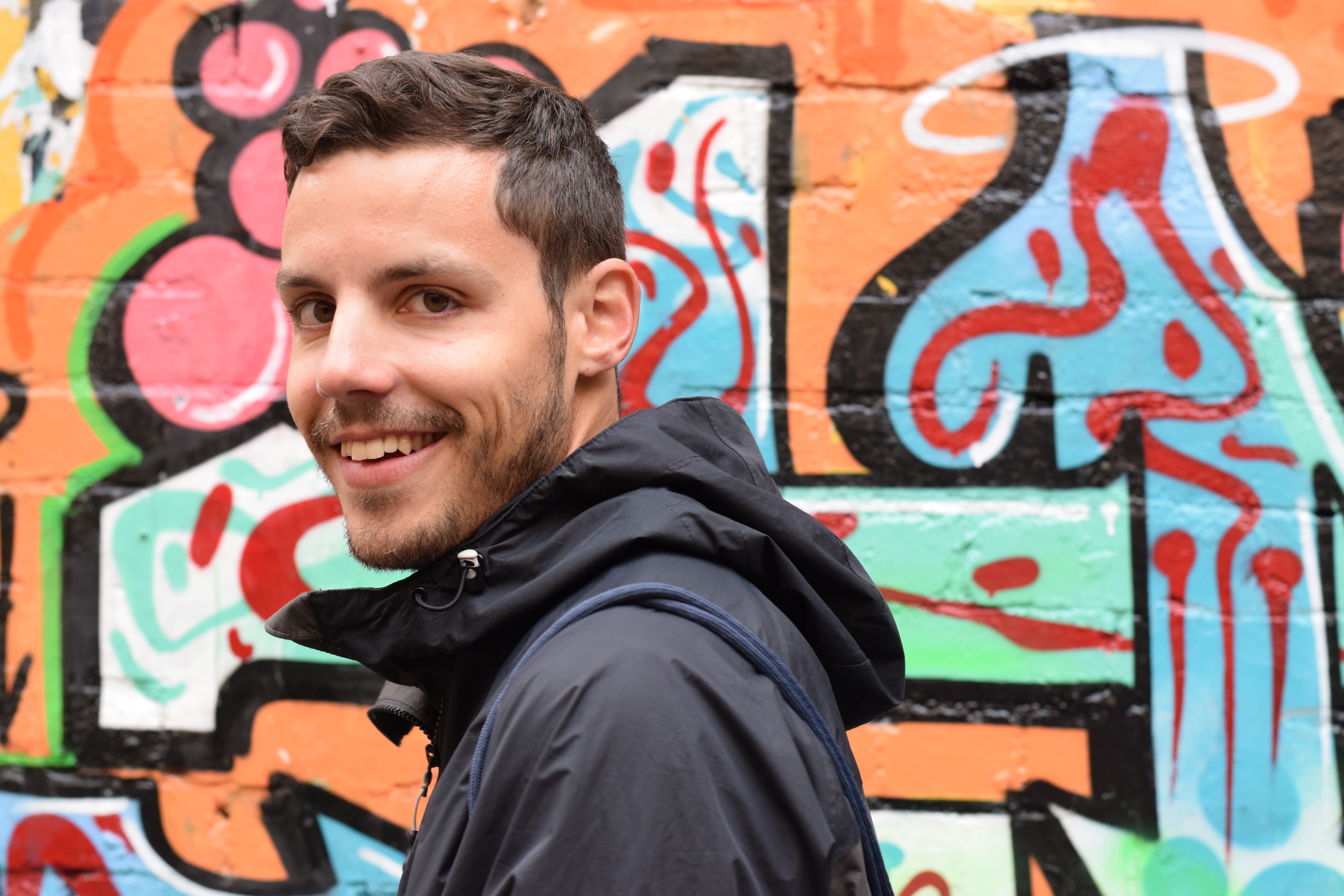 Manuel vor Grafitiwand